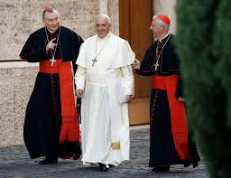 Pope Francis smiles as he walks alongside Vatican Secretary of State Pietro Parolin, left, and Cardinal Giuseppe Versaldi at the Vatican in 2014. AP Photo/Gregorio Borgia